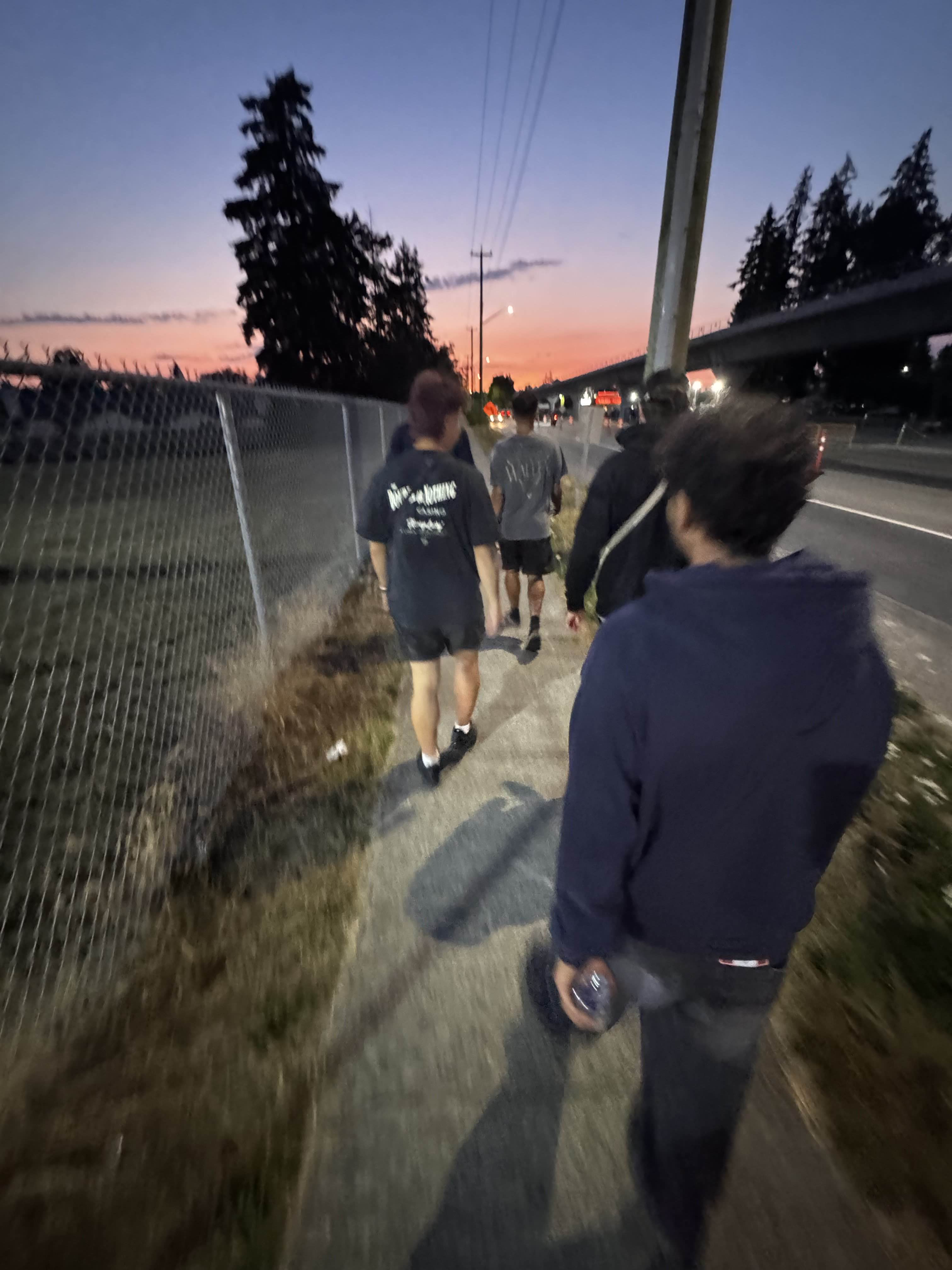 Walking along a road at sunset